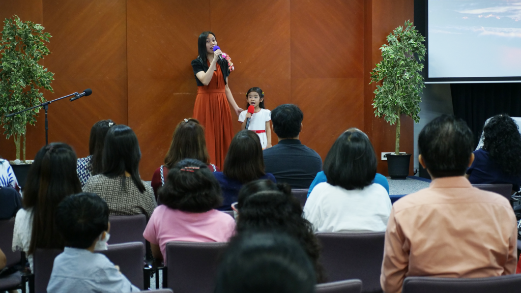 woman leading out in song service in a Filipino church