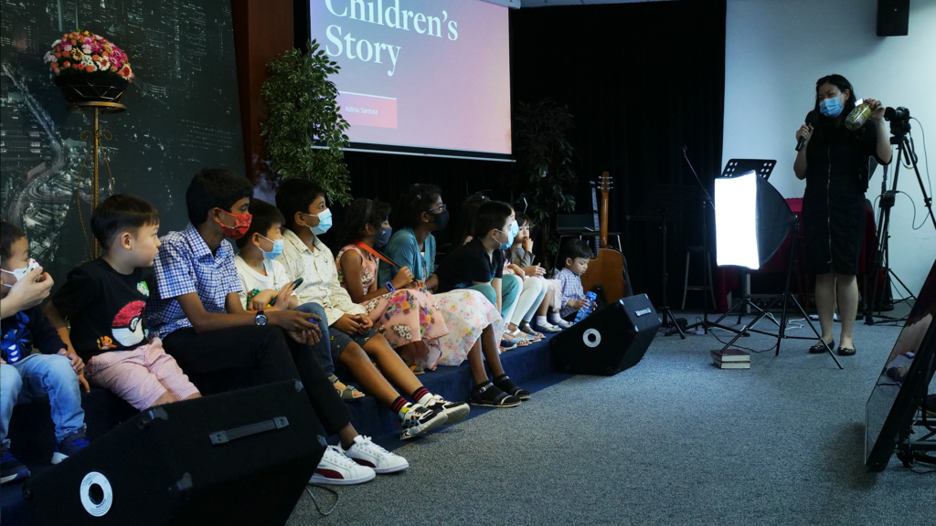 children listening to stories at Adventist Sabbath Church worship service
