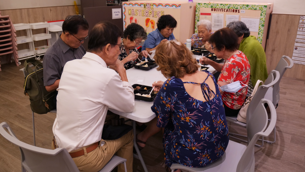 people having potluck lunch at a Chinese Adventist church in Singapore